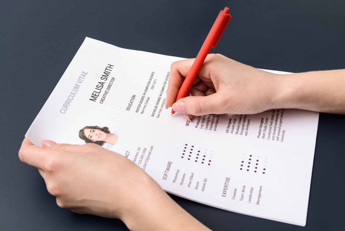 HR Manager Studying Job Resume of Candidate at Table
